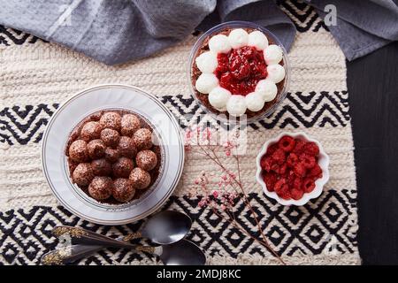 Aesthetic no baking vegan dessets. Trendy gluten free raspberry, cherry cupcakes flat lay. Dreamy Escapism concept. Stock Photo