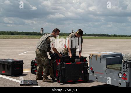 U.S. Air Force Senior Airmen Dakota Baccary, left, and Senior Airman Connor Berg, 75th Fighter Generation Squadron weapons load crew members, remove maintenance equipment from a box during exercise Agile Flag 22-2 at MacDill Air Force Base, Florida, July 24, 2022. Agile Flag 22-2 is Air Combat Command’s first lead-wing certification event designed to demonstrate the 23rd Wing’s capability to generate combat air power while continuing to move, maneuver, and sustain the Wing and subordinate force elements in a dynamic and contested environment. Stock Photo