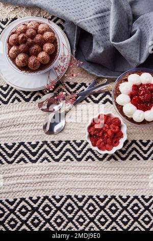 Aesthetic vegan dessets. Trendy no baking, gluten free raspberry, cherry cupcakes flat lay. Dreamy Escapism concept. Stock Photo