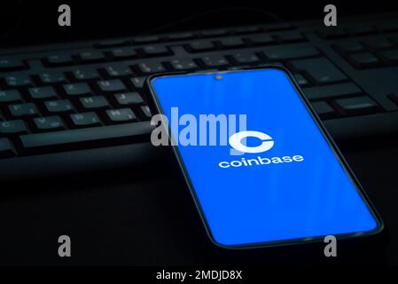 Ljubljana, Slovenia - 21 January 2023: Coinbase cryptocurrency exchange logo on smartphone screen laying on computer keyboard Stock Photo