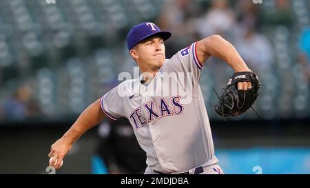 Texas Rangers starting pitcher Glenn Otto throws during the first inning of  a spring training baseball game against the Seattle Mariners Monday, March  28, 2022, in Peoria, Ariz. (AP Photo/Charlie Riedel Stock