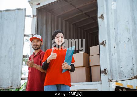 female worker and a delivery man with thumbs up Stock Photo