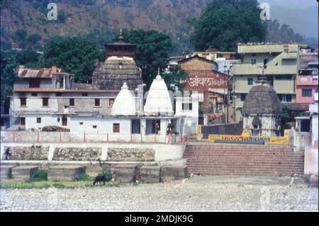 Bagnath Temple is an ancient shrine dedicated to Shiva, situated in the Bageshwar city at the confluence of Sarayu and Gomati rivers. Bagnath Temple is festooned with bells of all sizes and features impressive carvings. It is the most famous Temple in Bageshwar District. Stock Photo