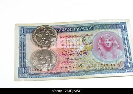 Background of old Egyptian money banknotes and coins of One Egyptian pound 1 EGP LE banknote bill of king Tutankhamen and coin of Orabi Revolution and Stock Photo