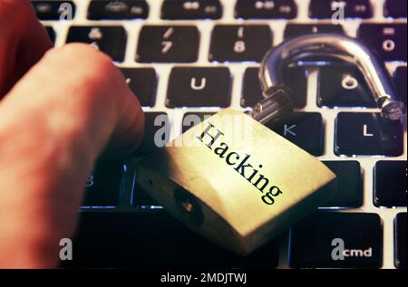 Hacked symbol on computer keyboard with open padlock Stock Photo