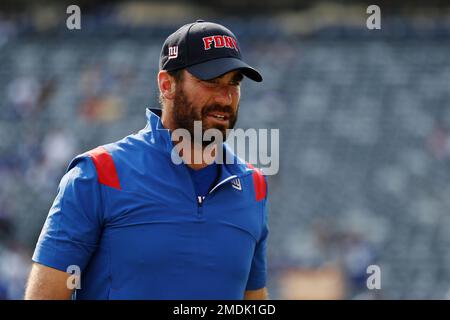 A New York Giants staff member wears an FDNY hat on the during