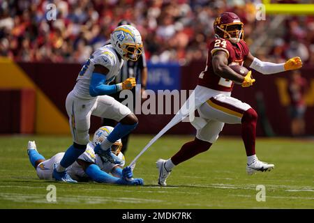 Los Angeles Chargers outside linebacker Kyzir White (44) tears the  undershirt of Washington Football Team running back Antonio Gibson (24)  after failing to stop Gibson during the first half of an NFL