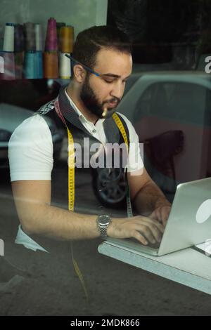 Tailor man working at his atelier Stock Photo