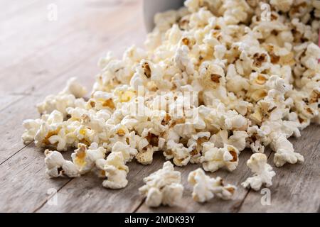 Salted popcorn scattered on wooden table Stock Photo