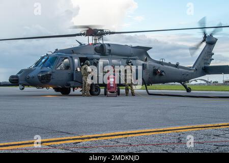 U.S. Air Force special missions aviators assigned to the 23rd Wing hot pit refuel an HH-60W Jolly Green II during exercise Agile Flag 22-2 at Avon Park, Florida, July 25, 2022. Hot pit refueling occurs while aircraft engines are running, eliminating downtime and allowing pilots to quickly return to the mission. Agile Flag 22-2 is Air Combat Command's first lead-wing certification event designed to demonstrate the 23rd Wing's capability to generate combat air power while continuing to move, maneuver, and sustain the Wing and subordinate force elements in a dynamic and contested environment. Stock Photo