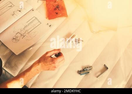 Man reading manual for self assembly furniture. Stock Photo