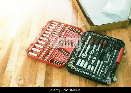 Tool box,set of bits and wrenches on laminated floor. Stock Photo
