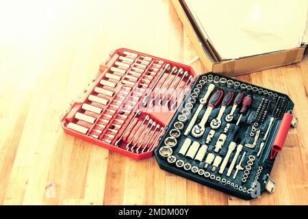 Tool box,set of bits and wrenches on laminated floor. Stock Photo