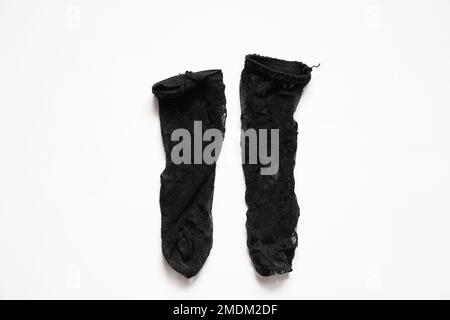 long black nylon dirty socks on a white background, old women's knee socks, socks Stock Photo