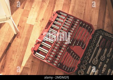 Tool box,set of bits and wrenches on laminated floor. Stock Photo