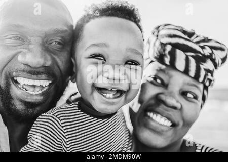 African family having fun outdoor - Main focus on baby eyes - Black and white editing Stock Photo