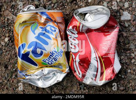 Aluminum cans, here Fanta and Coca Cola, that are flattened. Stock Photo