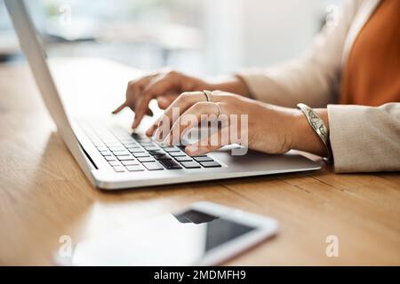 The secret is to keep on working until you succeed. an unrecognizable businesswoman working on a laptop on her office. Stock Photo