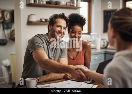 Were sure that youll get us the best deal. a handsome middle aged man shaking hands with a financial advisor during a consultation at home. Stock Photo