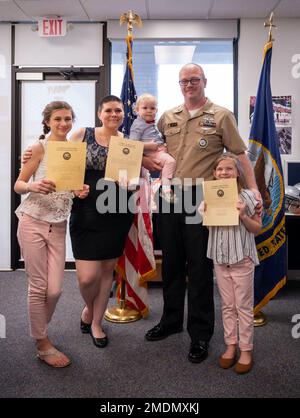 220726-N-WF272-1062 YORK, Pa. (July 26, 2022) U.S. Navy Firecontrolman (Aegis) 1st Class Christopher Odierno, a native of San Diego, assigned to Navy Talent Acquisition Group Philadelphia, poses for a photo with his family after reenlisting for six more years in the Navy at Navy Recruiting Station York, July 26, 2022. NTAG Philadelphia encompasses regions of Pennsylvania, New Jersey, Delaware, Maryland and West Virginia, providing recruiting services from more than 30 talent acquisition sites with the overall goal of attracting the highest quality candidates to ensure the ongoing success of Am Stock Photo