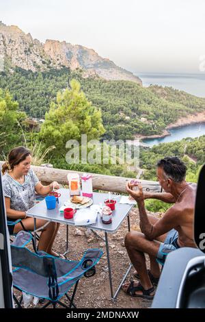 Father and daughter having breakfast in a motor home. Stock Photo