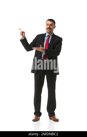 Businessman in a suit pointing with finger at blank space for text over white studio background. Plan, presentation. Concept of business, career Stock Photo