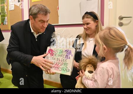 Prime Minister Dr. Markus Soeder and family minister Ulrike Scharf visit the language day-care center ?Neuhausen crèche? in Munich on January 23, 2023. A little girl gave Markus SOEDER (Prime Minister of Bavaria and CSU chairman) a gift as a thank you for the visit. ? Stock Photo