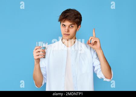 Young handsome man with drinking glass of water Stock Photo