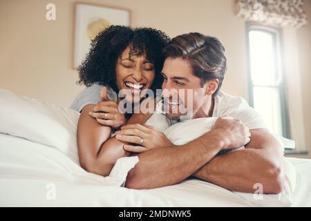 Happy and in love. an affectionate young couple spending some quality time together in their bedroom at home. Stock Photo