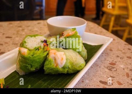 Fresh vietnamese spring rolls with peanut butter sauce for dipping. Stock Photo