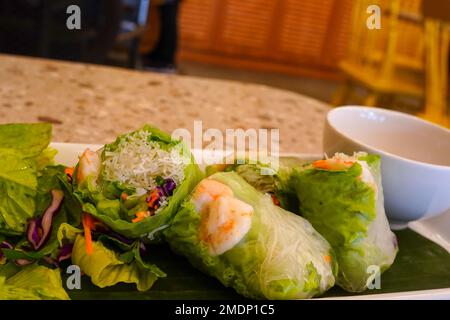 Fresh vietnamese spring rolls with peanut butter sauce for dipping. Stock Photo