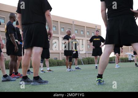 Maj. Gen. Michel M. Russell, Sr., commanding general of the 1st Theater Sustainment Command, takes the opportunity to mentor USARCENT civilian and military leaders before an early morning run as part of the USARCENT Commander’s Conference (ACC) at Camp Arifjan, Kuwait, 26 July, 2022.  The USARCENT Commander's Conference was hosted by Lt. Gen. Patrick Frank and Command Sgt. Maj. Jacinto Garza, where various topics were covered regarding Security Cooperation, Partnership Development, and Key Leadership Engagements. Stock Photo