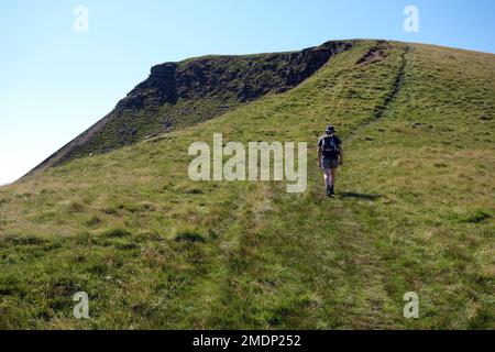 Man Walking on Ridge Path to the Nab on 'Wild Boar Fell' from High Dolphinsty near the Pennine Bridleway in the Eden Valley, Yorkshire Dales. UK. Stock Photo