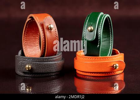 Leather bracelets with metal details on a dark background. Stock Photo