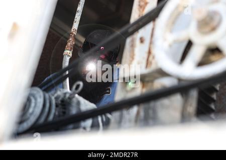 Bryan Anderson, a heating, ventilation, and air conditioning (HVAC) technician with Facilities Maintenance Branch, Public Works Division (PWD), Marine Corps Air Ground Combat Center (MCAGCC), operates on an air conditioning unit at MCGACC, Twentynine Palms, California, July 22, 2022. Despite the extreme heat of the high desert, the PWD, HVAC section maintains performance of air-cooling systems on buildings at the Combat Center. Stock Photo