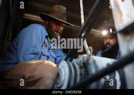 William Moody (left) and Bryan Anderson (right), a heating, ventilation, and air conditioning (HVAC) technician with Facilities Maintenance Branch, Public Works Division (PWD), Marine Corps Air Ground Combat Center (MCAGCC), operates on an air conditioning unit at MCGACC, Twentynine Palms, California, July 22, 2022. Despite the extreme heat of the high desert, the PWD, HVAC section maintains performance of air-cooling systems on buildings at the Combat Center. Stock Photo