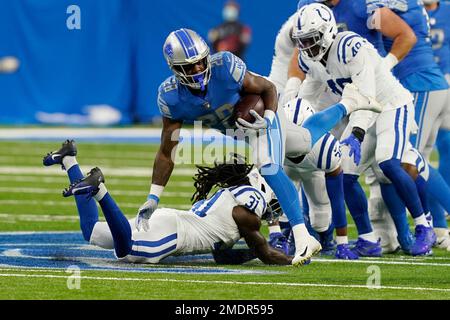 Detroit Lions running back Jermar Jefferson jumps over Indianapolis Colts  defensive back George Odum (30) during the first half of a preseason NFL  football game against the Indianapolis Colts, Friday, Aug. 27