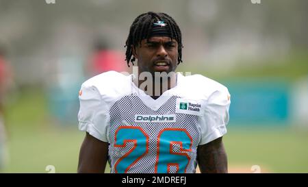 August 19, 2023: Miami Dolphins running back Salvon Ahmed (26) carries the  ball as Houston Texans safety Jimmie Ward (1) looks on after missing a  tackle during an NFL preseason game between