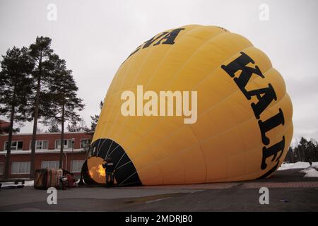 A hot air balloon flight in Finland. Photoshoot taken when the balloon was on the ground for fill up and during lift off and flight. Cold winter day Stock Photo