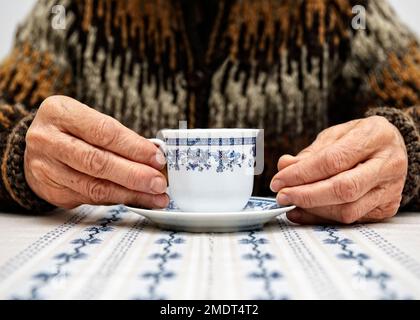 Female Pensioner Drinking a Cup of Coffee, United Kingdom Stock Photo