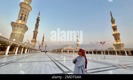 A traveler visiting the Al-Masjid an-Nabawi or the Prophet's Mosque in the city of Medina in the Al Madinah Province of Saudi Arabia Stock Photo