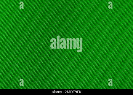 Texture of natural Green fabric. Fabric background from natural cotton or linen textile material. Red canvas background. Stock Photo