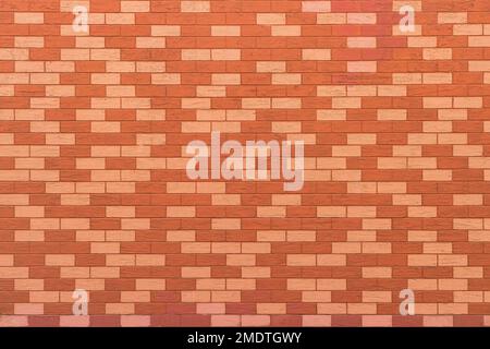 Texture of a wall covered with decorative brick-like tiles. Abstract background for design. Stock Photo
