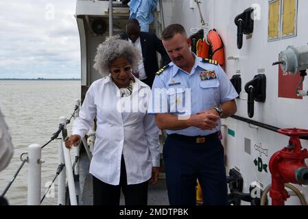 U.S. Coast Guard Cmdr. Andrew Pate, right, Commanding Officer of the Famous-class medium endurance cutter USCGC Mohawk (WMEC 913), speaks with Ambassador Sharon L. Cromer, US Ambassador to The Gambia, during a tour of the ship in Banjul, The Gambia, July 26, 2022. USCGC Mohawk is on a scheduled deployment in the U.S. Naval Forces Africa area of operations, employed by U.S. Sixth Fleet to defend U.S., allied, and partner interests. Stock Photo