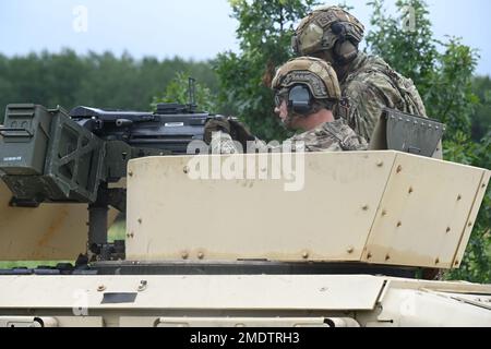 U.S. Air Force Staff Sgt. Pedro Mangual-Rivera, of the 219th Security Forces Squadron, right, provides overwatch during unit MK 19 (pounced Mark 19), American 40mm belt-fed automatic grenade launcher, mobile turret training held at Camp Ripley Minnesota July 26, 2022. The Airman were conducting training as part of a standard qualify course to prepare them for real world missile fields and deployment. Stock Photo