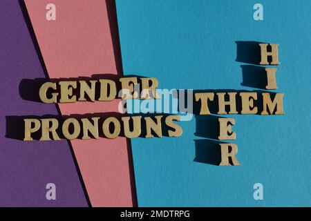 Gender Pronouns, Him, Her, Them, words and crossword in wooden alphabet letters isolated on background Stock Photo