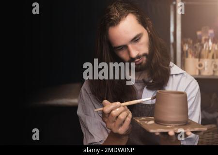 Master of handcraft pottery hand made cray pot. Fascinated Cup maker artist work with intention. Stock Photo