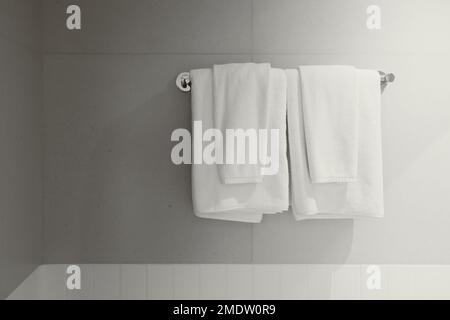 Towel white clean new rack hanging shower room service in hotel bathroom Stock Photo