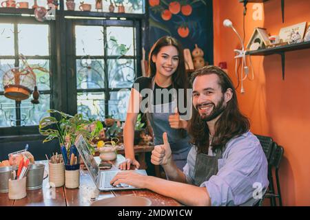 happy artist pottery workshop owner couple friend together enjoy small business with love Stock Photo