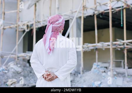 Sheikh Arab man looking at under construction building for build new office business project owner concept Stock Photo